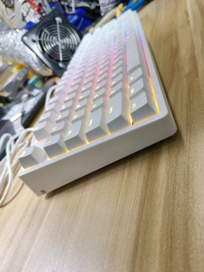 Bàn phím cơ IKBC F410 trắng đèn RGB vàng cam, góc nghiêng trên mặt bàn gỗ